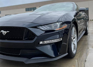The front end of a Ford Mustang that's been freshly detailed