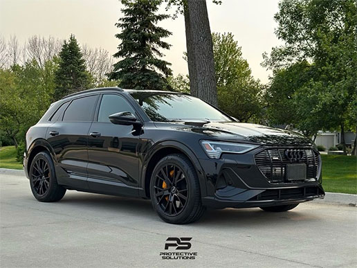 An all-black SUV with paint protection film